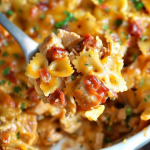 A forkful of BBQ Ranch Chicken Casserole showcasing the creamy pasta and crispy bacon bits for a perfect bite.