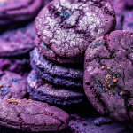 Golden-baked blueberry cookies with a rich, deep purple hue, highlighting their tender texture