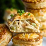 Close-up of a flaky chicken pie revealing its creamy chicken and vegetable filling.