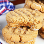 Close-up of freshly baked peanut butter sandwich cookies filled with creamy peanut butter.