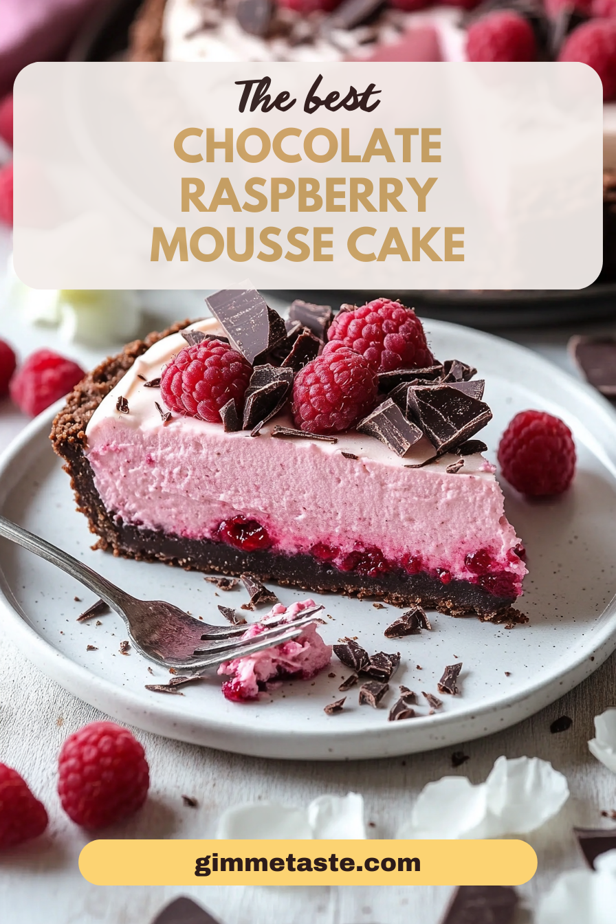 Chocolate Raspberry Mousse Cake decorated with whole raspberries and dark chocolate shavings on a ceramic plate, highlighting the vivid pink mousse and dense chocolate base.