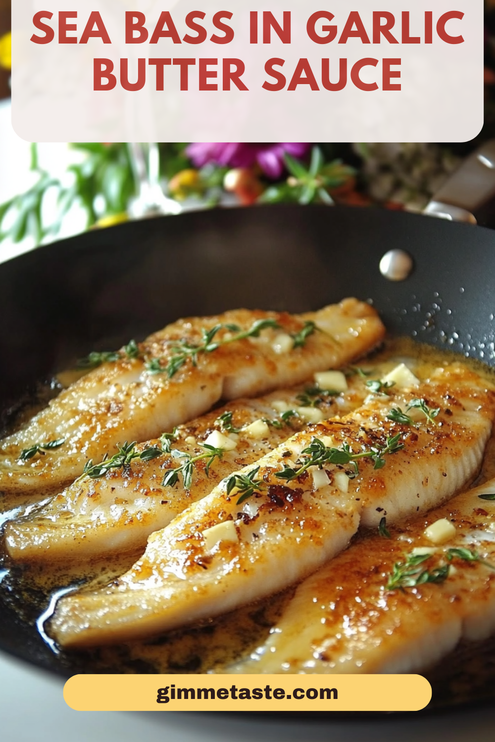 Pan-seared sea bass fillets in garlic butter sauce, garnished with fresh thyme, served in a skillet with a vibrant floral background, showcasing the dish's golden, crispy texture and aromatic appeal.