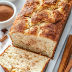 Cinnamon Swirl Cake sliced in a white baking dish, showcasing its moist texture and rich cinnamon sugar layers.