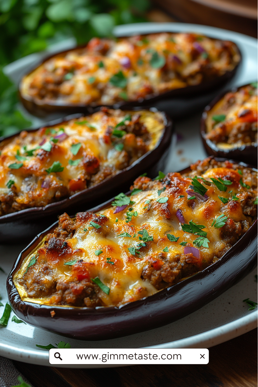 Close-up of Spanish stuffed eggplants filled with ground meat, onions, peppers, and cheese, garnished with fresh parsley.