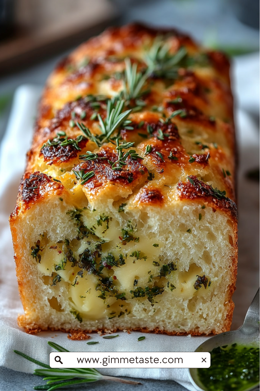 Cheese, Herb & Garlic Quick Bread (No Yeast) with golden crust, scattered herbs, and a moist interior filled with pockets of cheese and fresh herbs.
