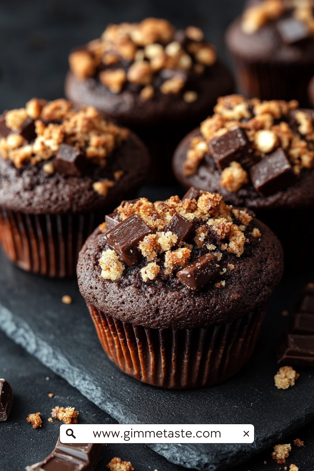 Chocolate Coffee Toffee Crunch Muffin with crumbly streusel topping on a wooden board.
