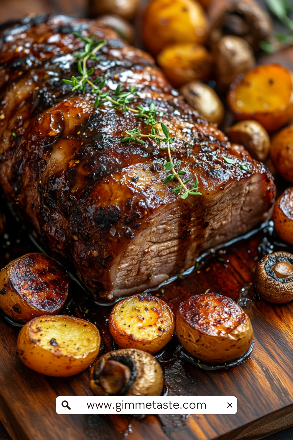 Slow Cooker Balsamic Glazed Pork Roast with golden honey glaze, rosemary sprigs, and roasted vegetables on a wooden cutting board.