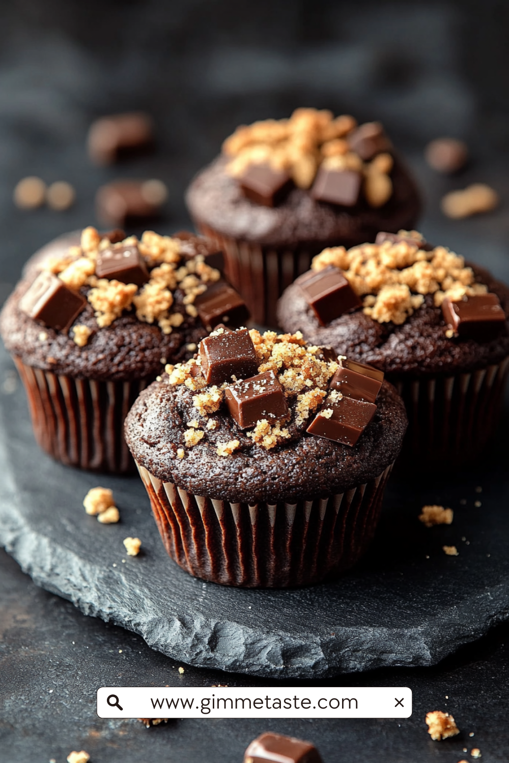 Chocolate Coffee Toffee Crunch Muffin with crumbly streusel topping on a wooden board.