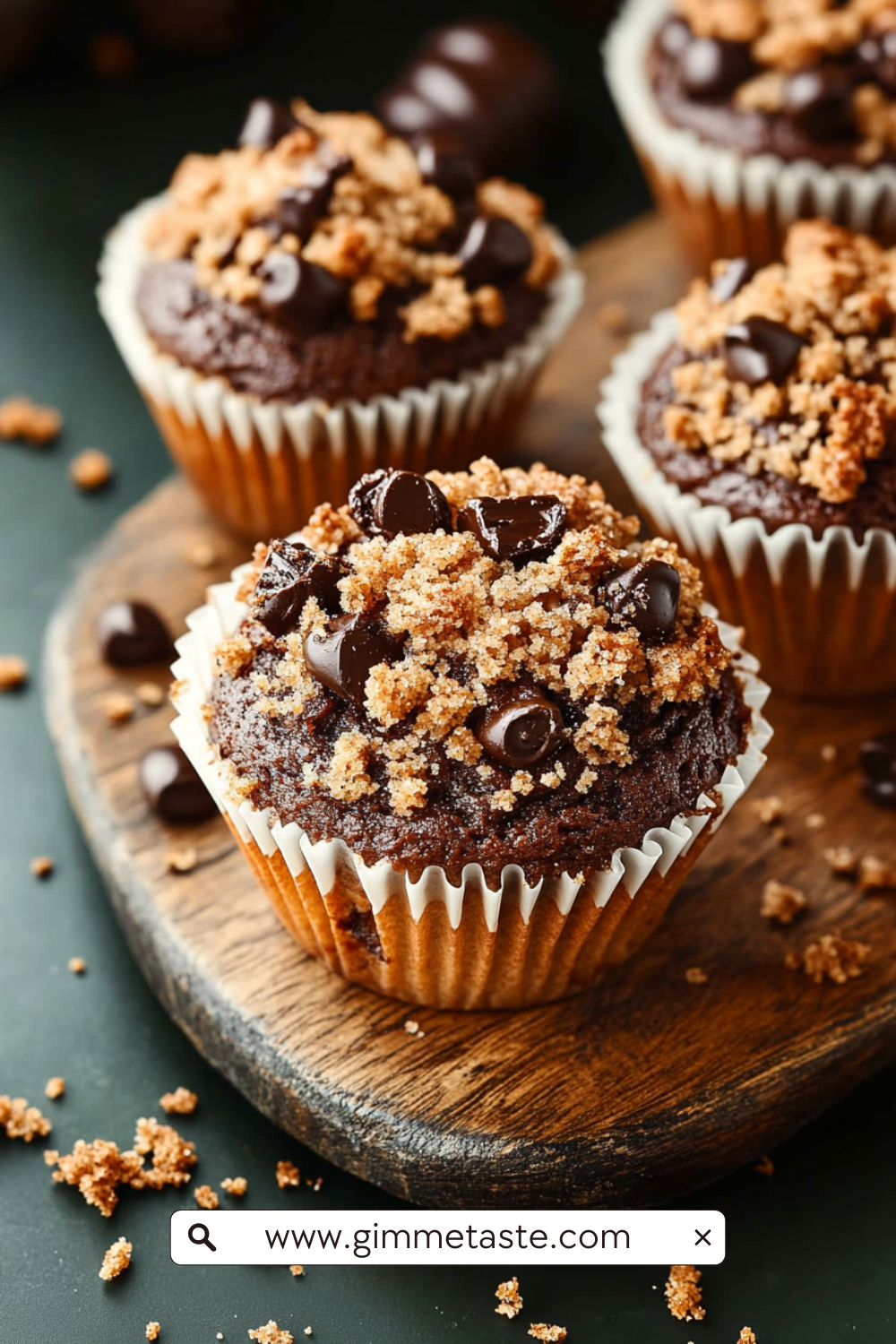 Chocolate Coffee Toffee Crunch Muffin with crumbly streusel topping on a wooden board.