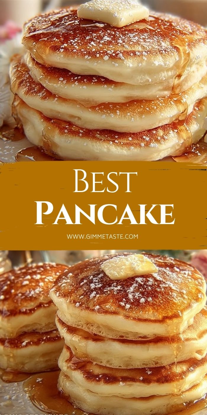 A stack of golden-brown pancakes on a plate, dusted with powdered sugar, surrounded by a bowl of butter cubes, a bottle of milk, and a bowl of flour.
